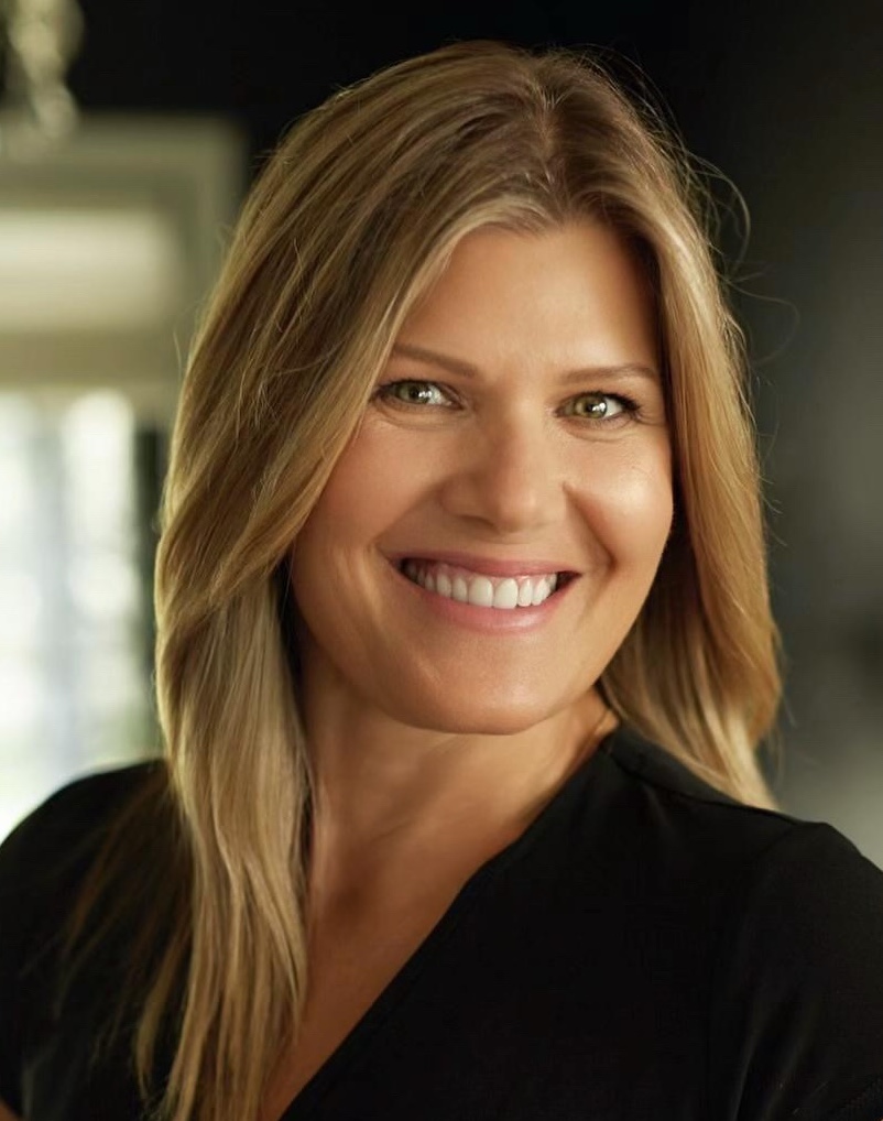 A tractor plows a sunlit field at dawn, creating dust while lush green crops flourish along the edge of the dirt path