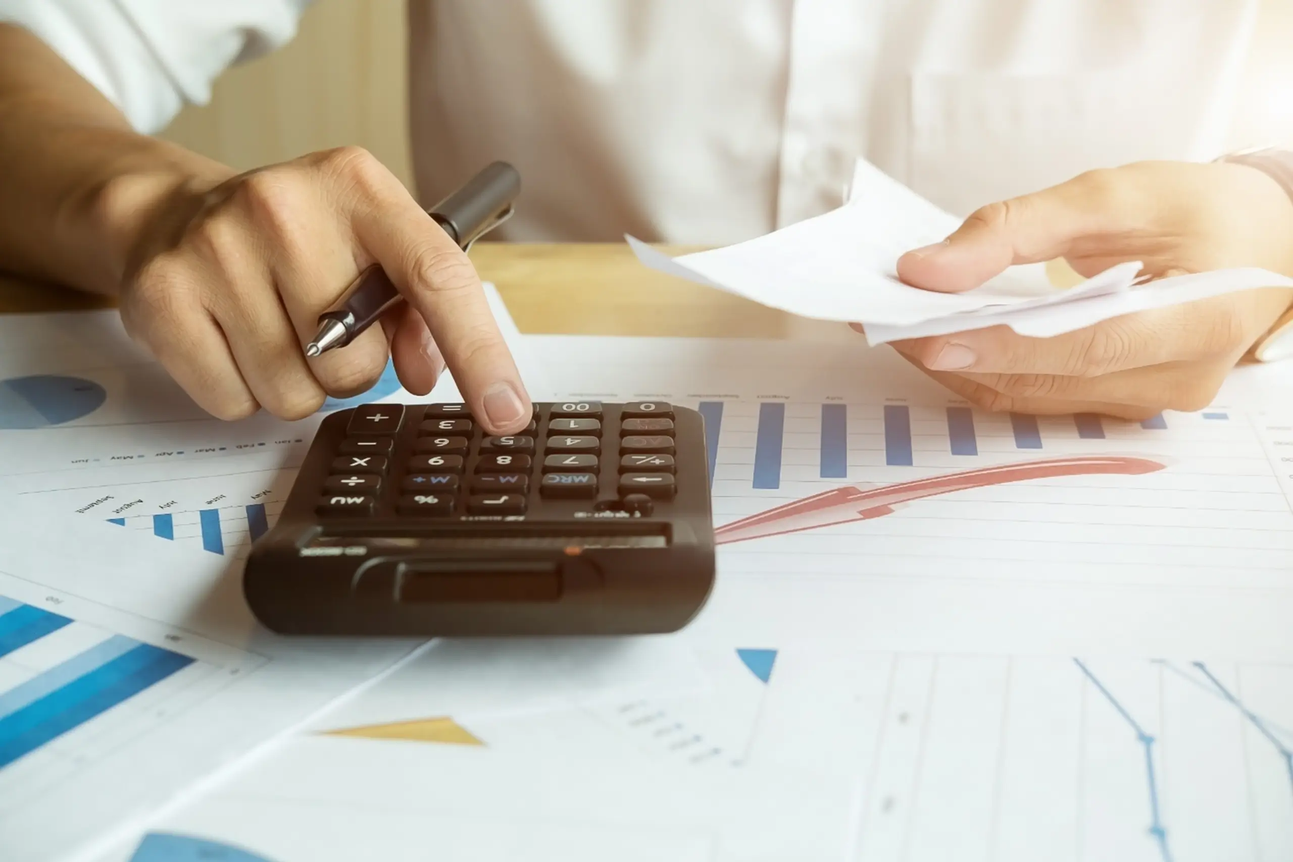 A man and a child stand together in a golden wheat field, gazing out at the horizon under a clear sky